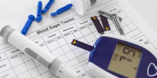 Diabetic-test-kit-on-blood-sugar-tracker-sheet